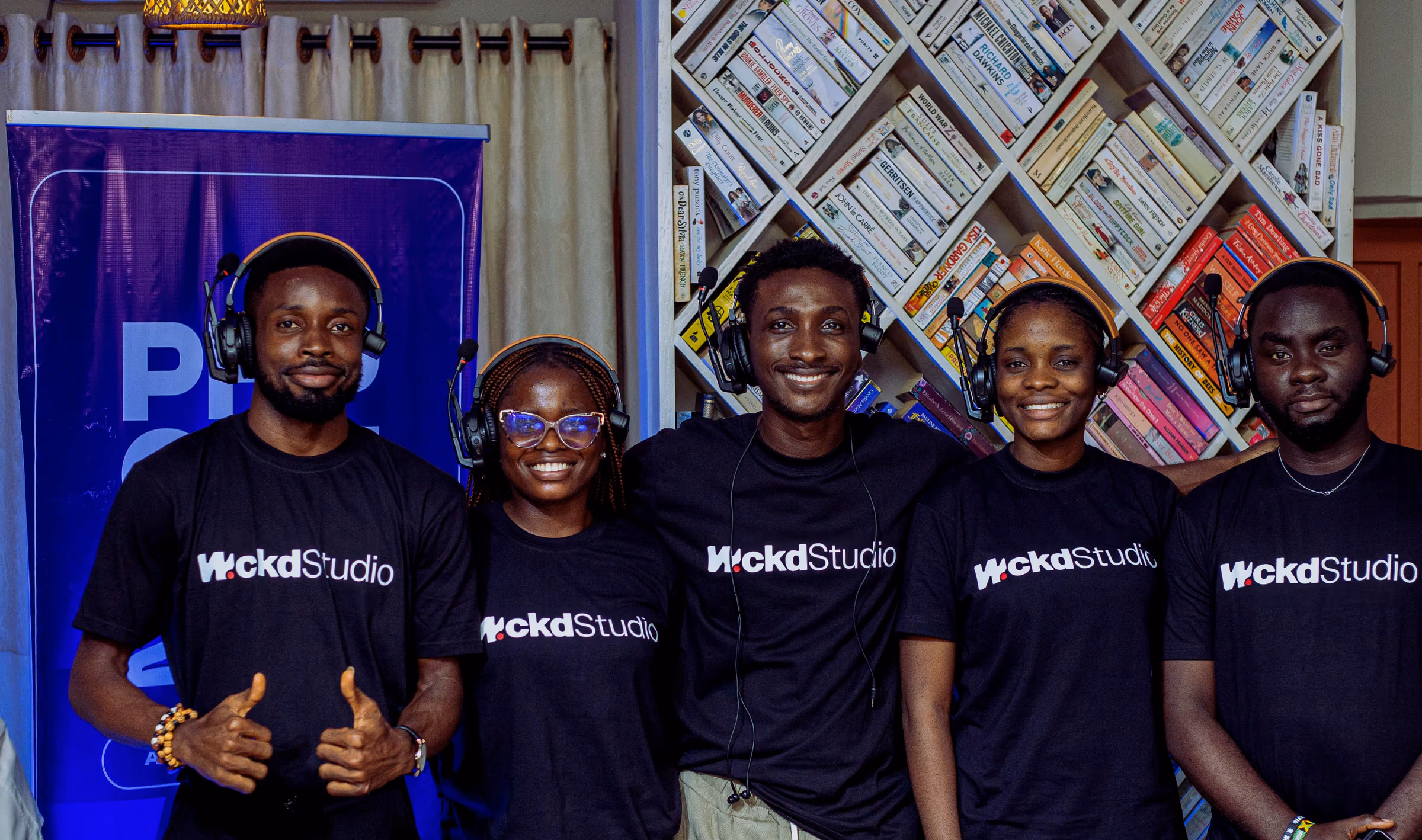 The WCKD crew in branded tees and headsets
