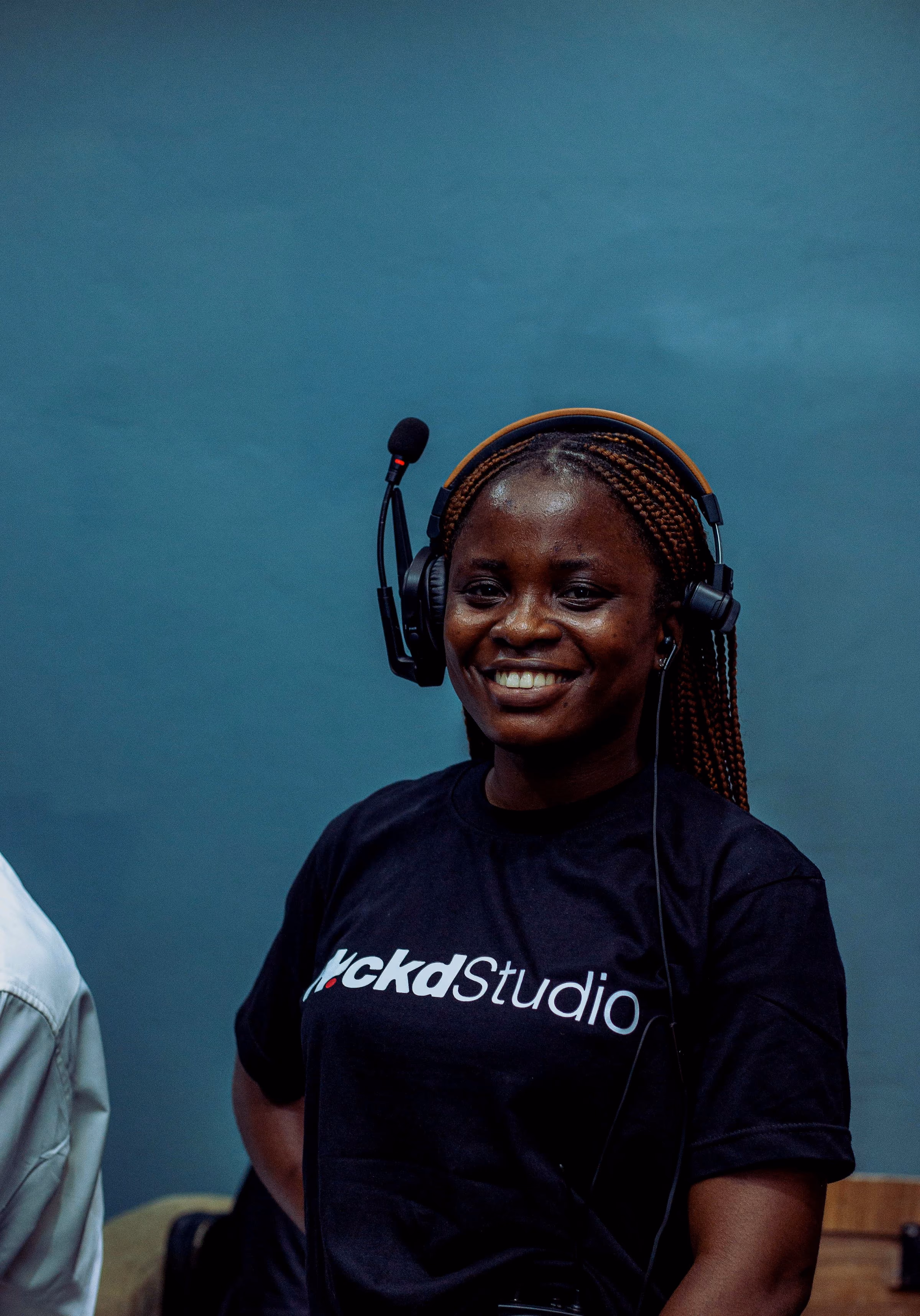 Crew member in a WCKD Studio tee wearing a comms headset
