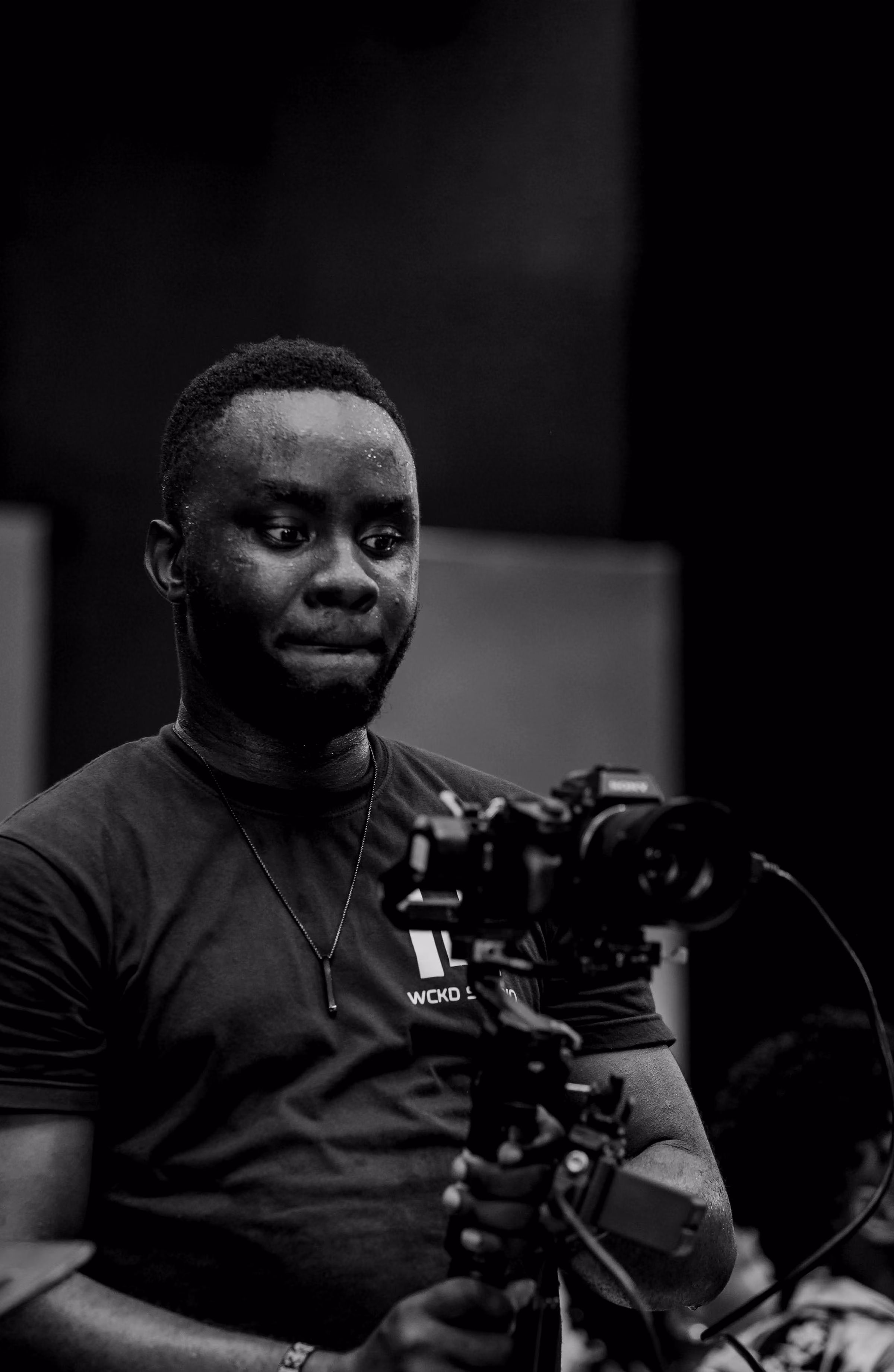 Black-and-white portrait of a camera operator with a gimbal